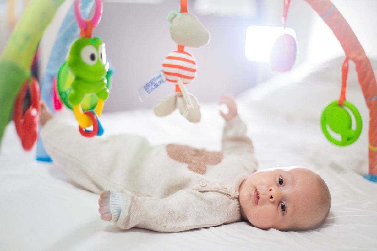 Baby laying in baby gym