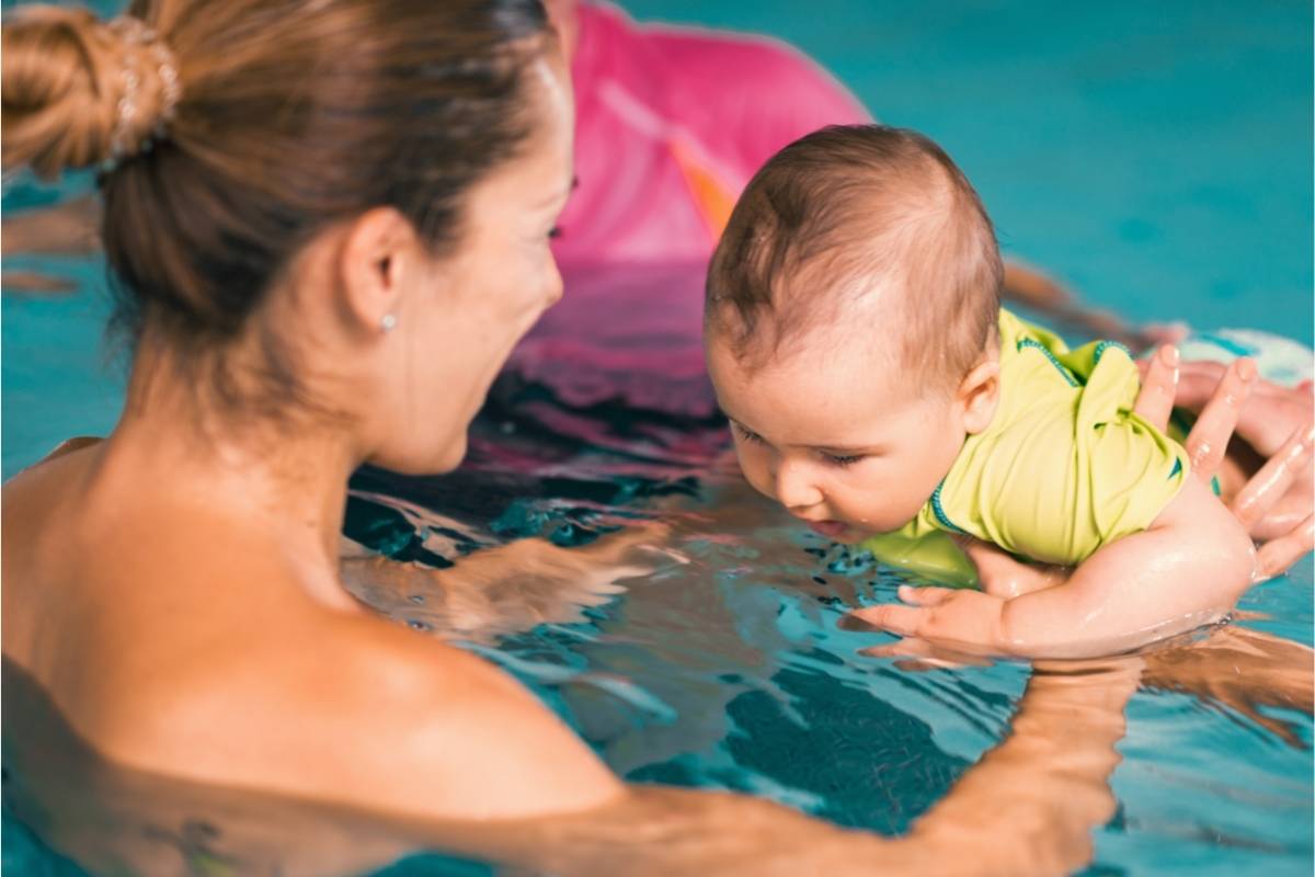 Baby at swimming classes with mother